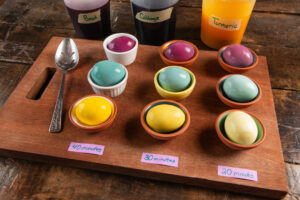 Dyed eggs in different shades of yellow, bluegreen and red, left soaking at 20 minutes, 30 minutes and 40 minutes.