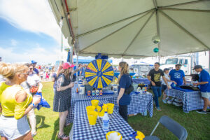 Sponsor Tent activities at the festival include spinning the prize wheel, shown here, for free merchandise.