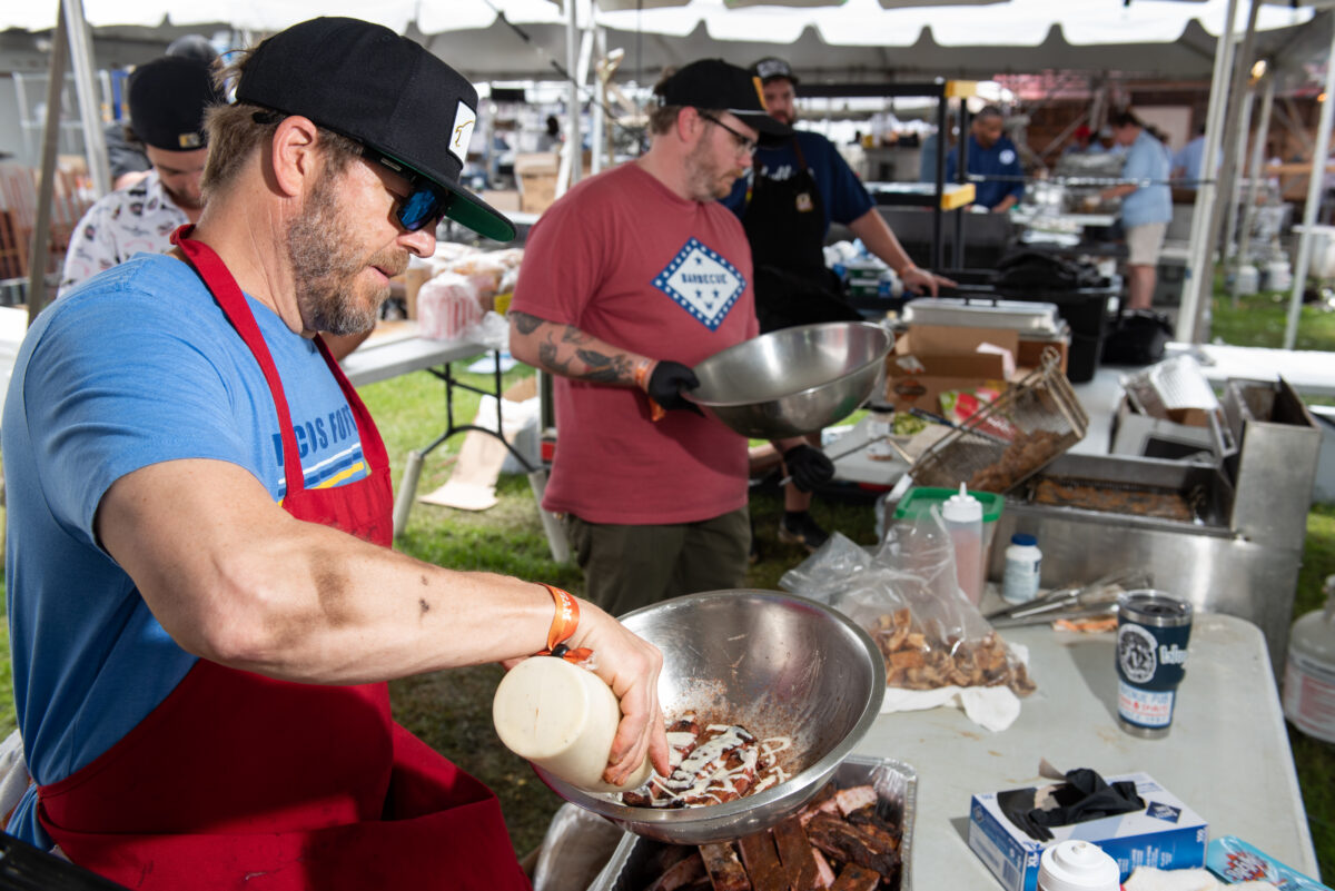 hogs for the cause contestants hard at work serving up great BBQ